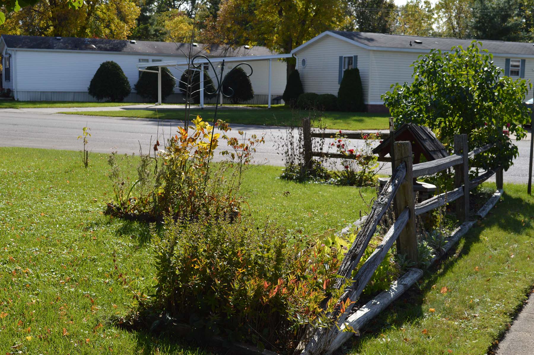Split-rail fence and flower garden in the community