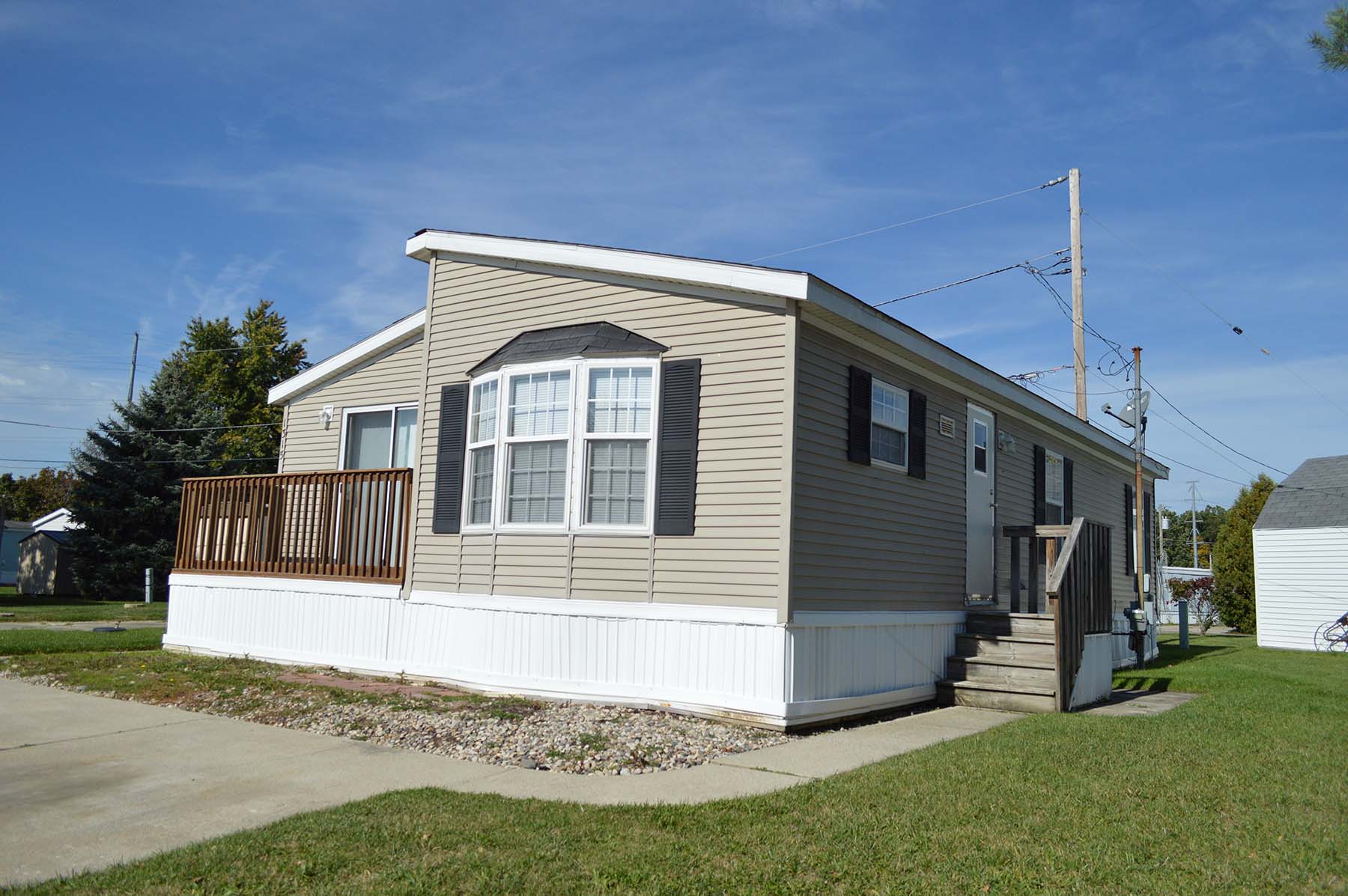 Manufactured home with side deck and driveway